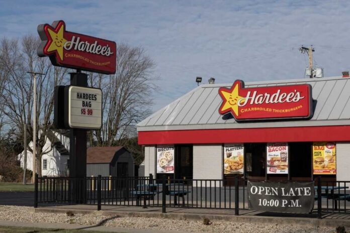 Exterior view of a Hardee's fast food restaurant with a sign and menu