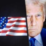 Close-up of a political figure with an American flag in the background