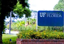 Sign for the University of Florida surrounded by greenery and flowers