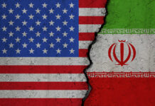 United States and Iran flags divided by crack