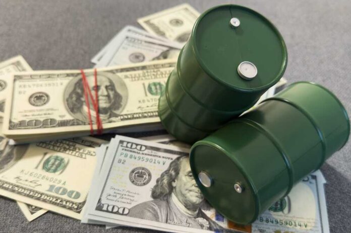 Two green barrels placed on a pile of hundred dollar bills