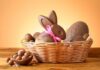 A basket filled with various chocolate Easter treats including a bunny and eggs