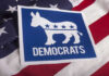 Democrats logo on American flag background.