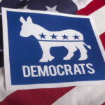 Democrats logo on American flag background.