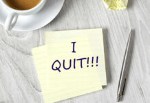 Note with I QUIT near coffee, pen, paper ball.