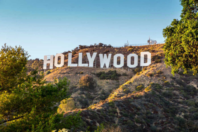 Hollywood Sign on a green hillside, sunny day.