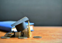 Graduation cap on top of coins to represent student loans