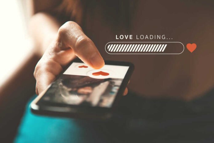 A hand holding a smartphone displaying a love loading screen