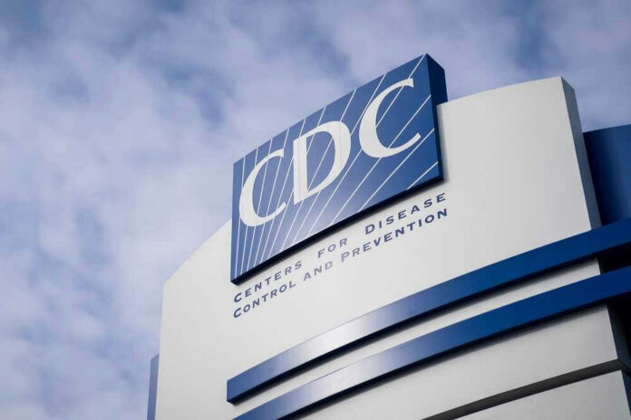 CDC building sign against a cloudy sky.