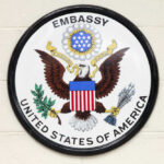 Seal of the United States Embassy featuring an eagle and national colors