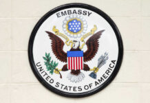 Seal of the United States Embassy featuring an eagle and national colors