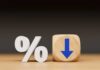 A percentage symbol next to a wooden block with a downward arrow
