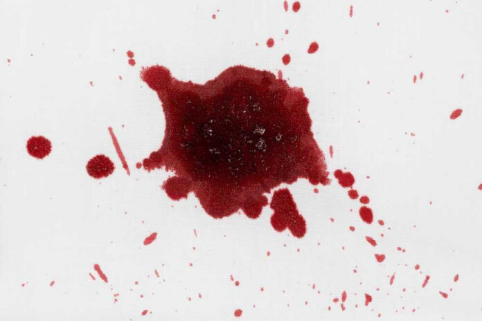Red liquid splatter on a white background.