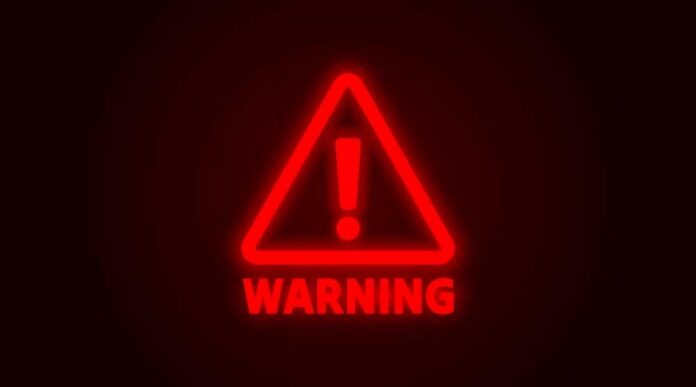 Red neon warning sign with an exclamation mark