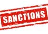 Red stamp with the word 'SANCTIONS' in bold white letters