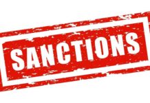 Red stamp with the word 'SANCTIONS' in bold white letters