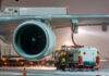 Ground crew fueling an aircraft during snowy weather