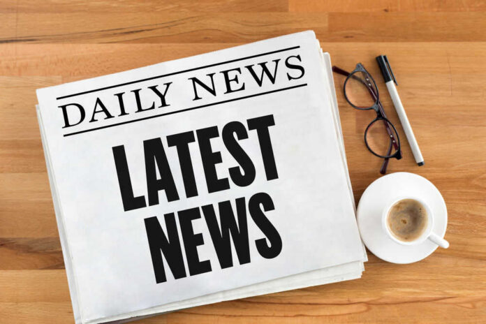 Newspaper with headline latest news on table