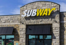 Exterior view of a Subway restaurant with a prominent sign