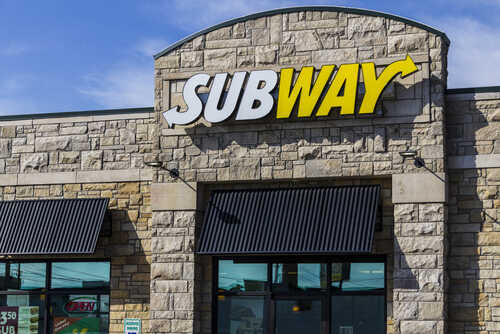 Exterior view of a Subway restaurant with a prominent sign