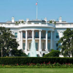 The White House, front view with fountain and flag.