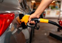 A person refueling a car at a gas station