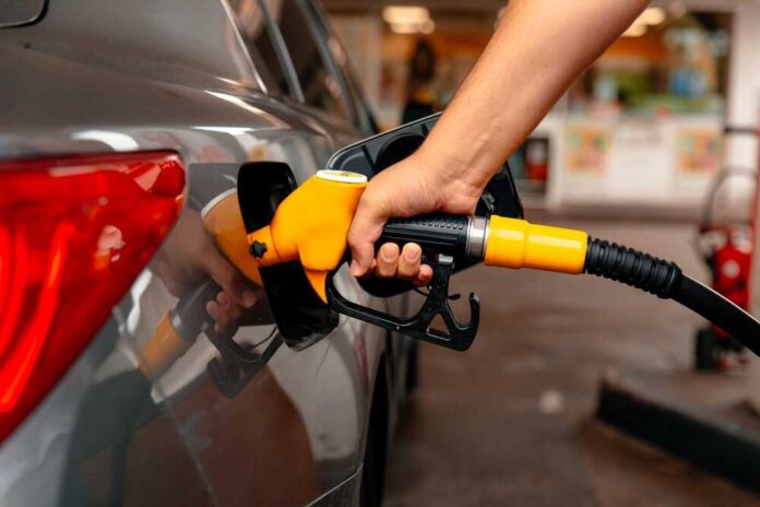 A person refueling a car at a gas station