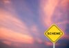 A yellow warning sign with the word 'SCHEME' against a colorful sky