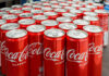 Coca-Cola cans stacked on a surface.