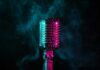A vintage microphone surrounded by colorful smoke