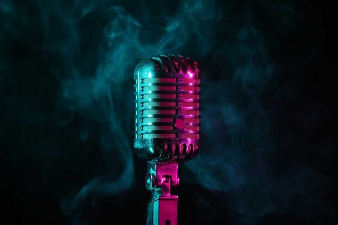 Retro,Microphone,And,Smoke,On,Dark,Background,,Closeup A vintage microphone surrounded by colorful smoke