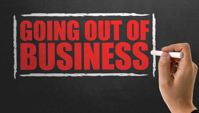 Going,Out,Of,Business A hand writing 'GOING OUT OF BUSINESS' on a chalkboard