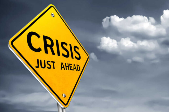 A yellow warning sign indicating a crisis ahead
