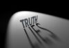 Truth casting shadow spelling Lies on curved surface.