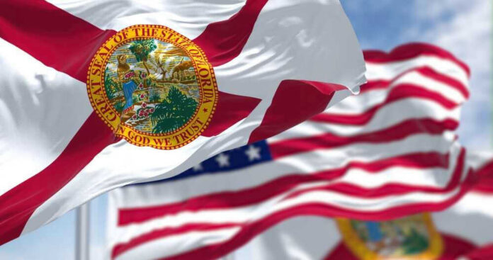 shutterstock_2163513923 Florida state flags waving in the wind.