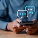 Person holding a smartphone with chat bubbles above
