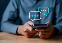 Person holding a smartphone with chat bubbles above