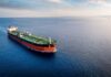 An oil tanker navigating through calm ocean waters