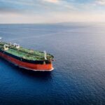 An oil tanker navigating through calm ocean waters