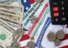 Various denominations of U.S. currency and financial documents on a flag background