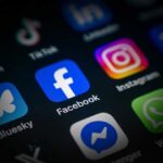 Close-up of various social media application icons on a smartphone screen