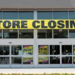 Storefront with a large 'STORE CLOSING!' banner and sale signs