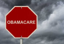 Red stop sign labeled Obamacare cloudy sky background