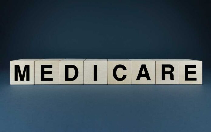 Wooden,Blocks,Spelling,Out,The,Word,Medicare.,This,Image,Symbolizes Wooden blocks spelling out MEDICARE on a dark background