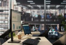 Computer monitor with analytics dashboard in a modern open office