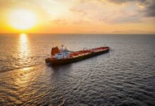 Oil tanker sailing at sunset on open sea