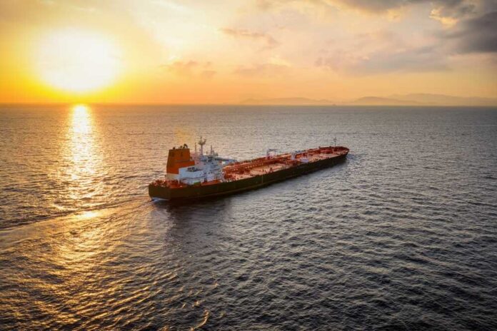 Oil tanker sailing at sunset on open sea