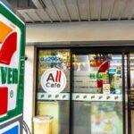 Exterior view of a 7-Eleven convenience store with All Cafe signage