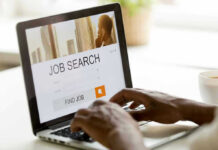 Person searching for jobs on a laptop.