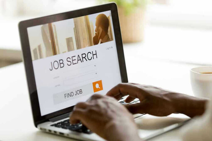 Person searching for jobs on a laptop.